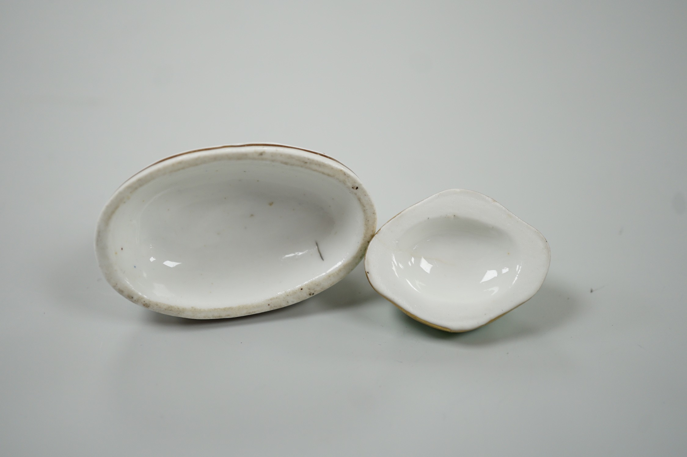 Two toy Staffordshire models of a recumbent rabbit and a bunny, both on oval bases, c.1830-50, (2). Tallest 4cm, Provenance Dennis G.Rice collection